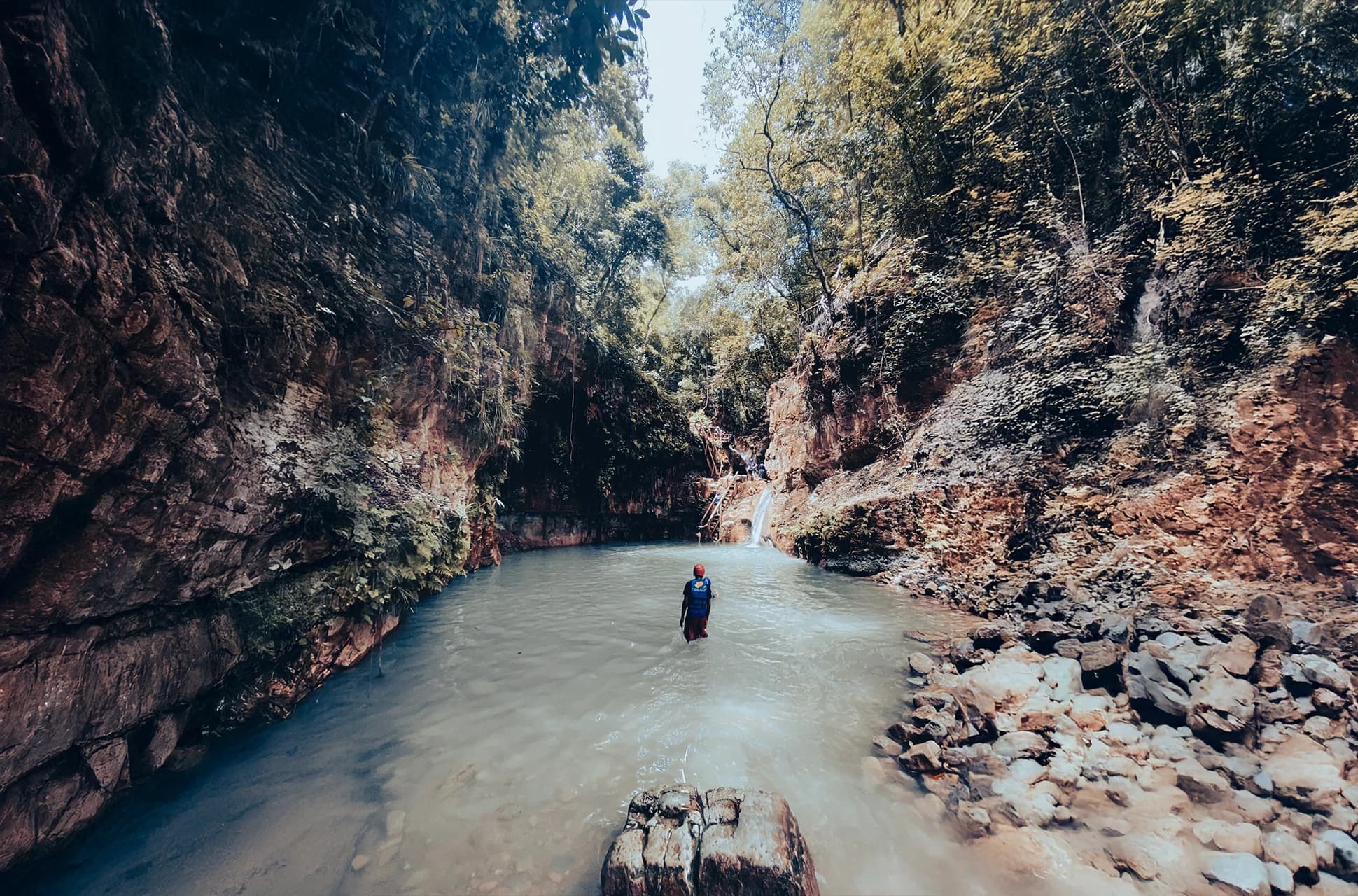 Visitor exploring the turquoise pool at 27 Waterfalls of Damajagua in Puerto Plata, Dominican Republic.