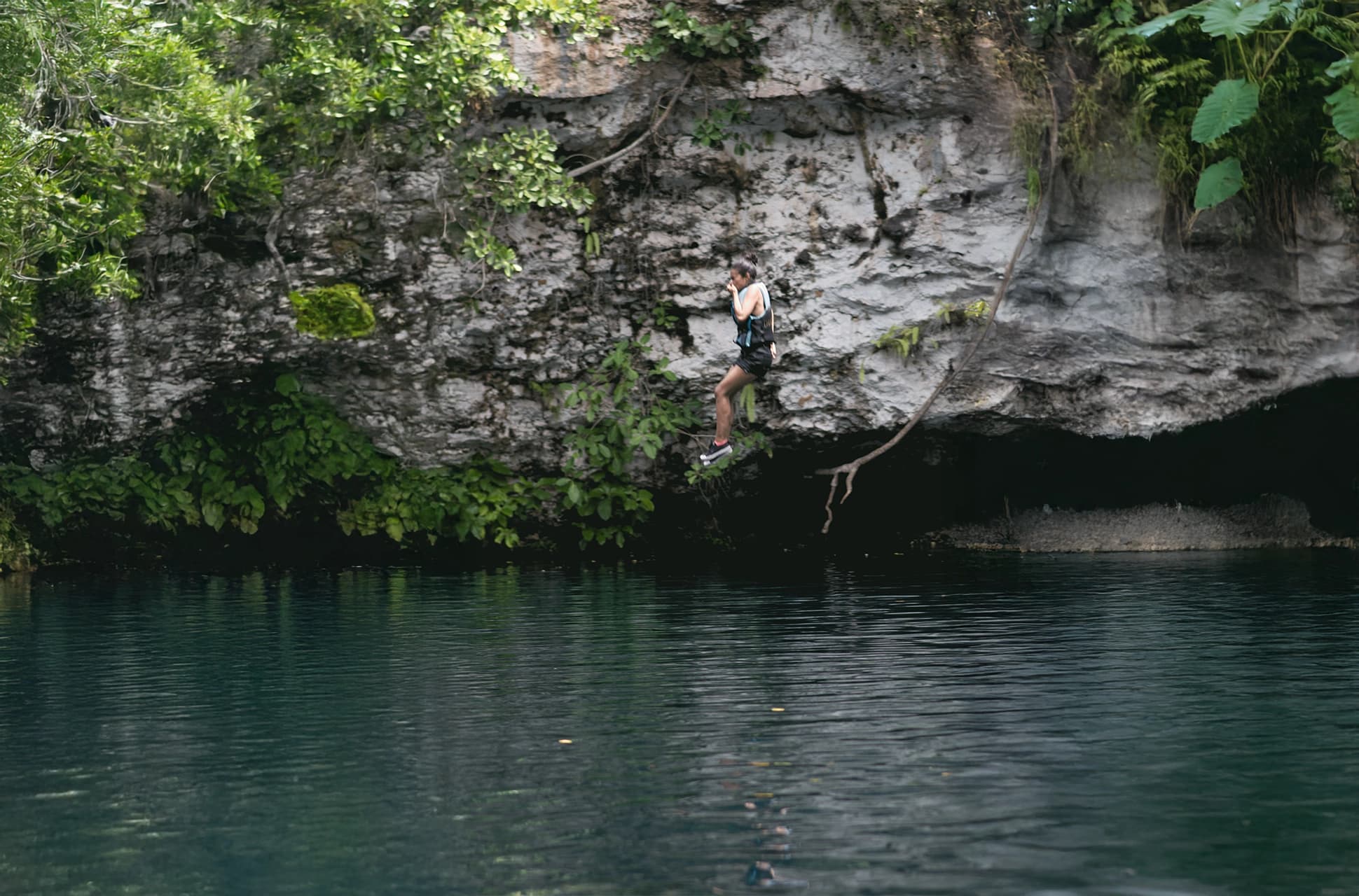 Traveler jumping into the turquoise waters of Laguna Dudú