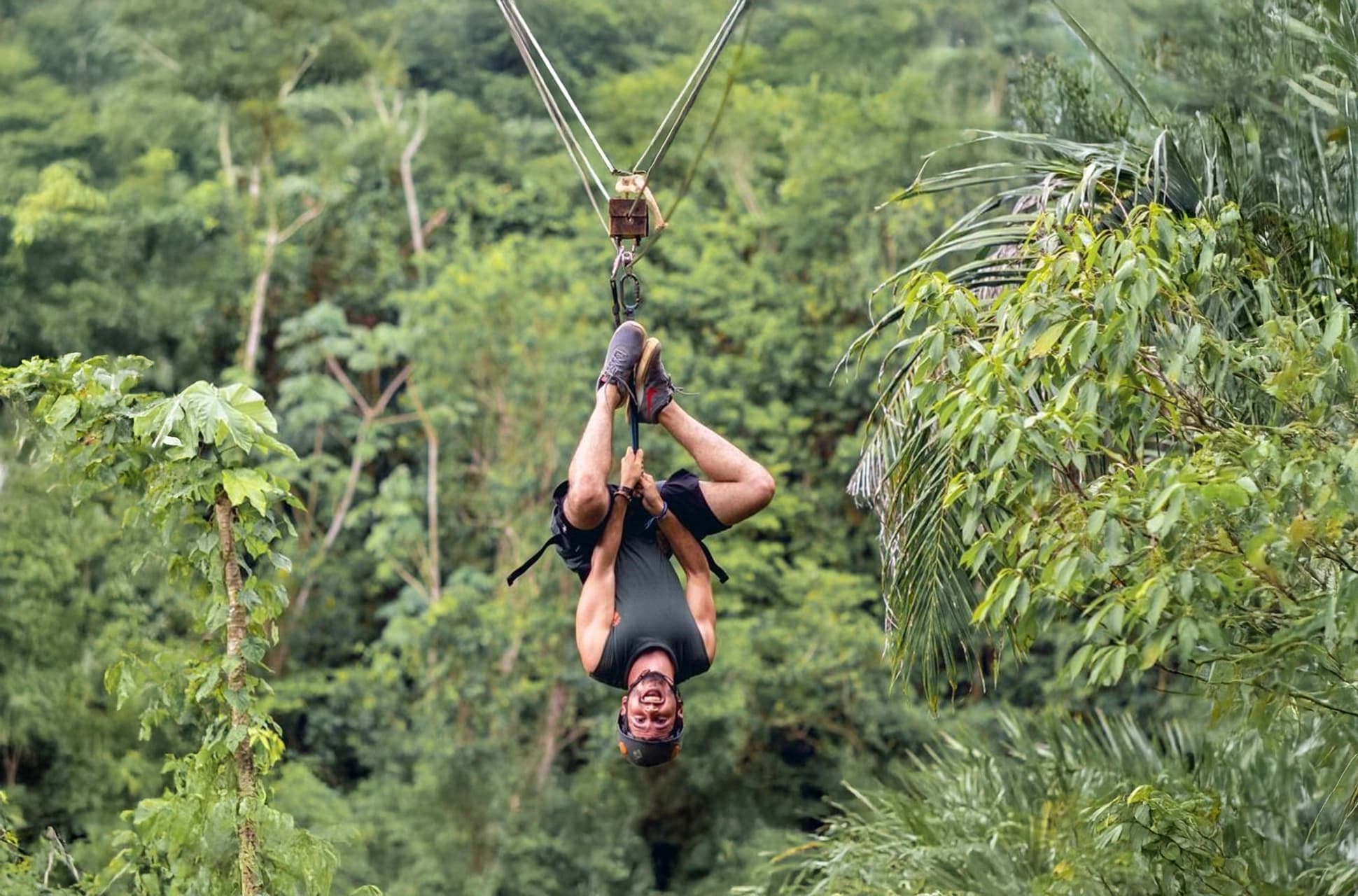 Tourist enjoying an upside-down ride on the Samaná Zipline in the Dominican Republic.